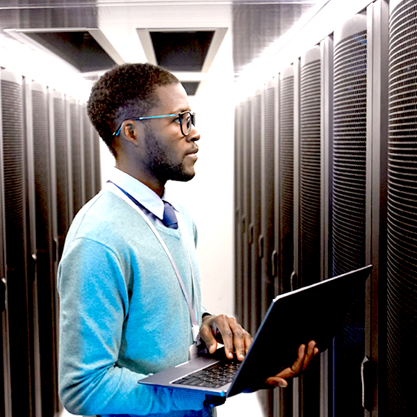 Man with laptop in a datacenter